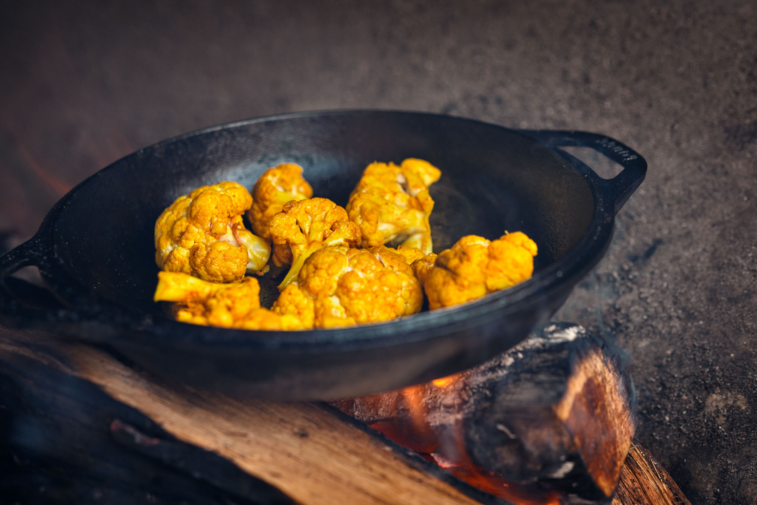 Cauliflower cooking on an open fire at Southern Junction BBQ in Buffalo NY